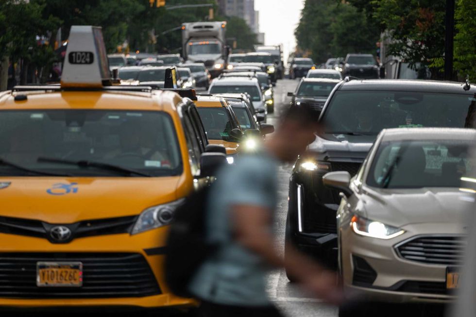 Pedestrians and cars move through Midtown Manhattan traffic on June 6, 2024