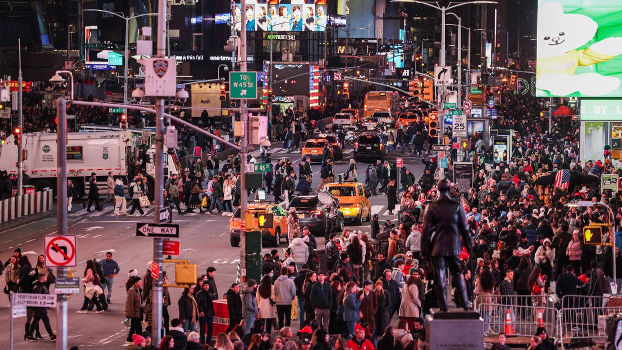 Pedestrians and vehicles move through Times Square on Nov. 12, 2025