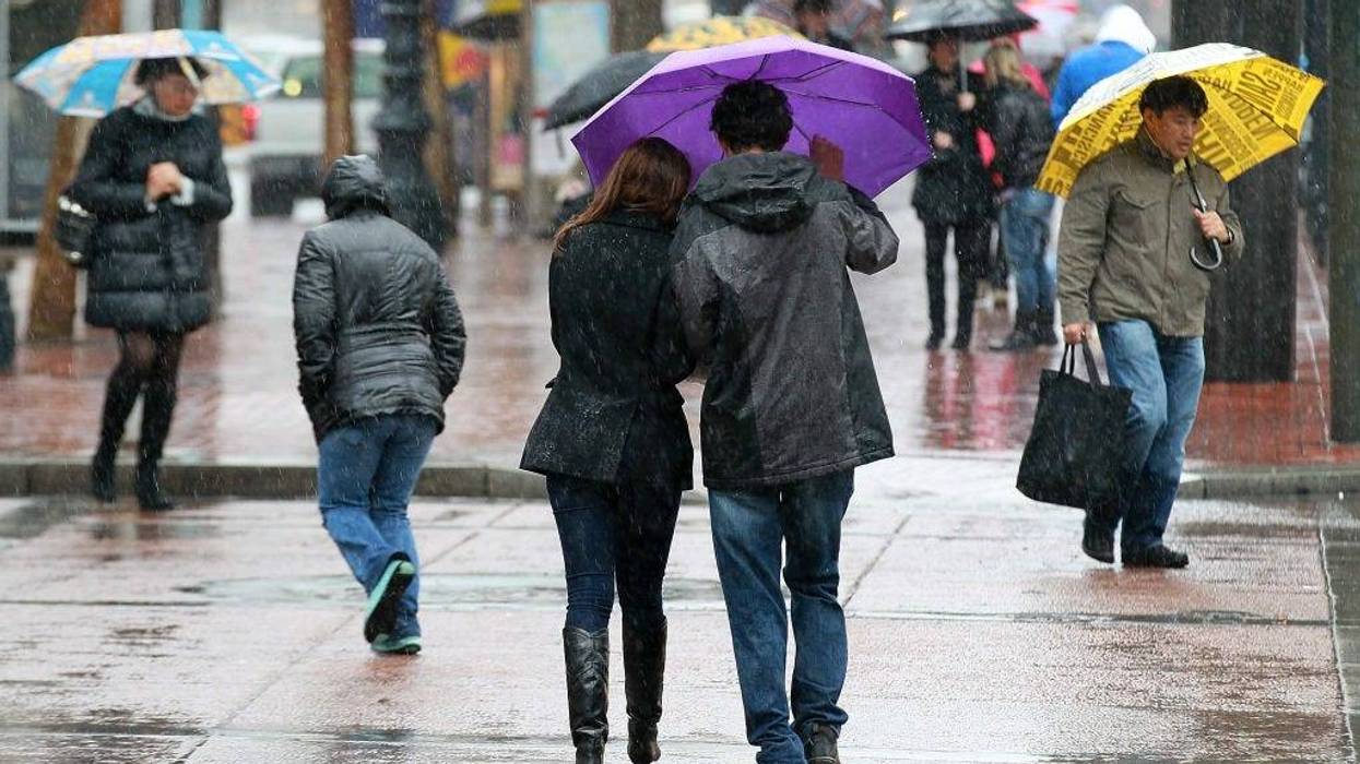 Pedestrians carry umbrellas as they walk down Market Street on February 17, 2011 in San Francisco, California.