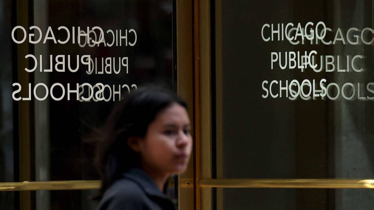 Pedestrians pass Chicago Public Schools Headquarters on Madison Street in Chicago on May 28, 2024.