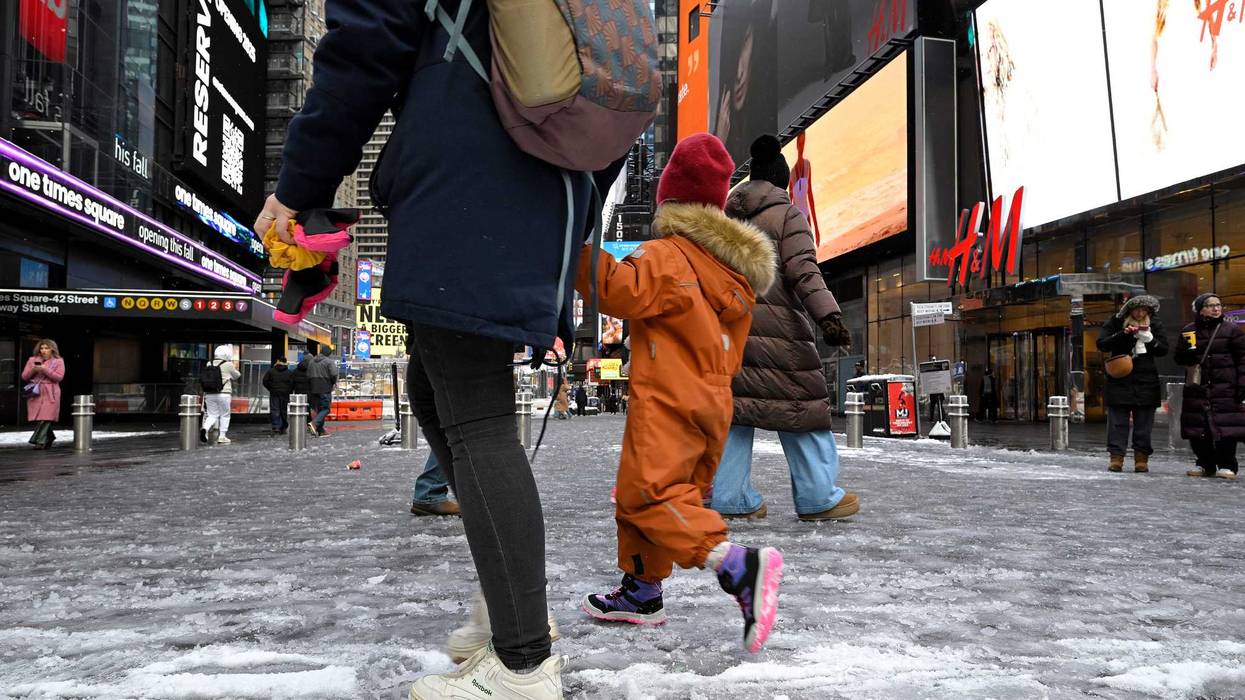 Pedestrians walk along wet and slushy streets in Manhattan.