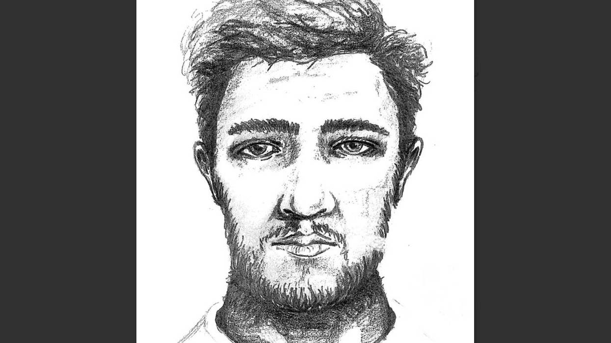Pencil sketch of a man's face, with short messy hair and a beard, looking directly.