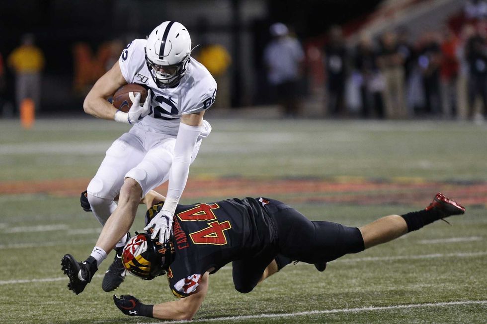 Penn State Nittany Lions tight end Zack Kuntz (82) runs with the ball past the tackle of Maryland Terrapins linebacker Chance Campbell (44) in the fourth quarter at Capital One Field at Maryland Stadium.