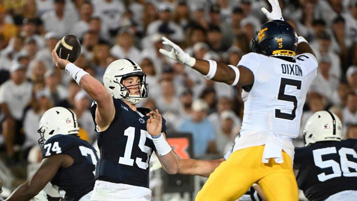 Penn State quarterback Drew Allar (15) passes while pressured by West Virginia linebacker Lance Dixon (5) during the second half of an NCAA college football game, Saturday, Sept. 2, 2023, in State College, Pa. (AP Photo/Barry Reeger)