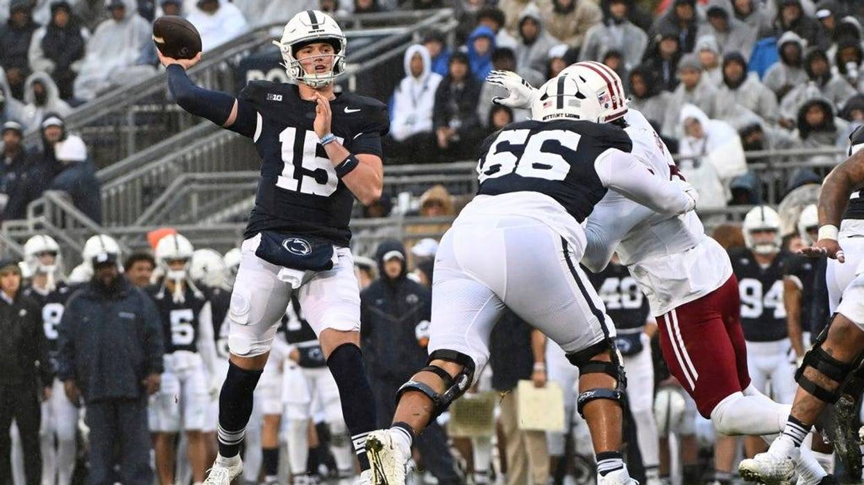 Penn State quarterback Drew Allar (15) throws a touchdown pass to tight end Tyler Warren (44) during the first half of an NCAA college football game against Massachusetts, Saturday, Oct. 14, 2023, in State College, Pa. (AP Photo/Barry Reeger)