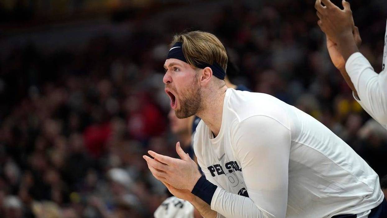 Penn State's Michael Henn cheers on his teammates during the first half of an NCAA college basketball championship game against Purdue at the Big Ten men's tournament