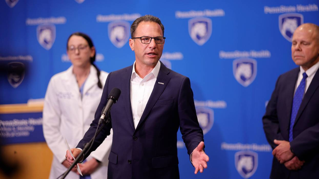 Pennsylvania Governor Josh Shapiro speaks to the media in front of a backdrop for Penn State Health in Hershey Pennsylvania.