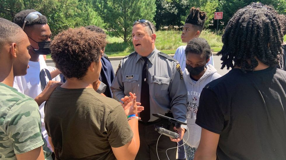 Pennsylvania State Trooper Jim Trumpio talking to students at a STEM camp at Lower Merion High School.