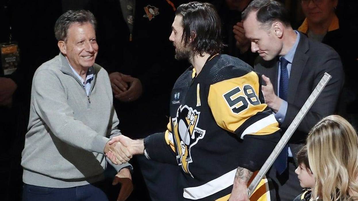 Pennsylvania, USA; Fenway Sports Group chairman Tom Werner (left) and Pittsburgh Penguins president Kevin Acklin (right) congratulate defenseman Kris Letang (58)
