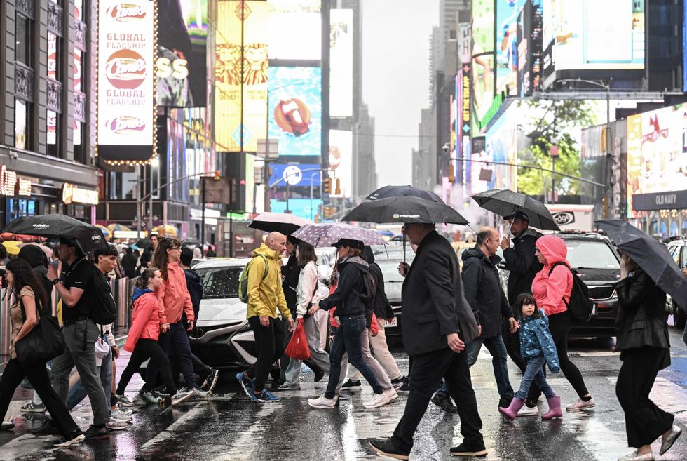 People across a street near Times Square on Aug. 8, 2024