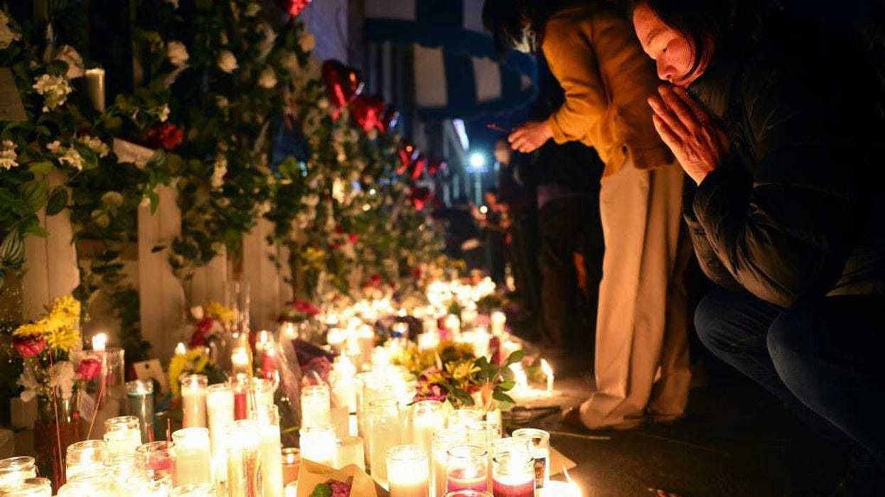 People attend a candlelight vigil at the growing memorial outside the Star Ballroom Dance Studio where a deadly mass shooting took place on January 25, 2023 in Monterey Park, California.