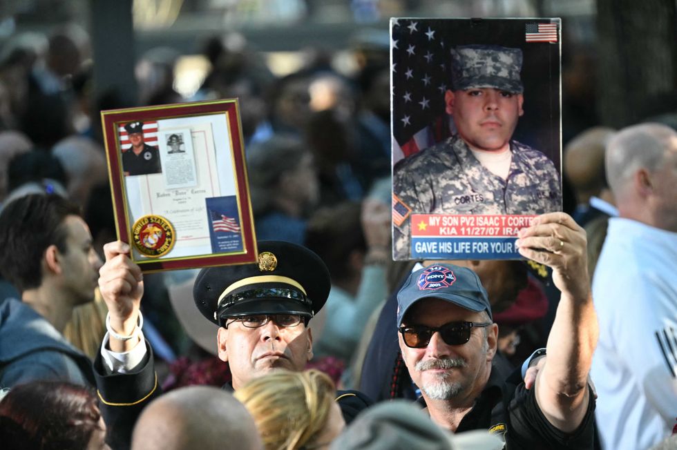 People attend a remembrance ceremony on the 23rd anniversary of the September 11 terror attacks