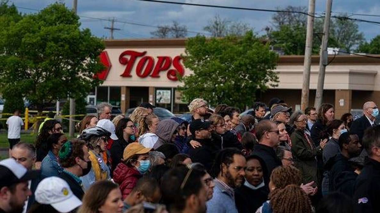 People attend a vigil across the street from Tops Friendly Market at Jefferson Avenue and Riley Street on Tuesday, May 17, 2022 in Buffalo, NY. The Supermarket was the site of a fatal shooting of 10 people at a grocery store in a historically Black neighborhood of Buffalo by a young white gunman is being investigated as a hate crime and an act of racially motivated violent extremism, according to federal officials.