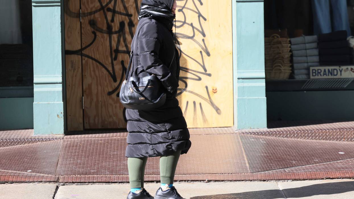People bundle up as they shield themselves from cold winds as the area is seeing record-breaking low temperatures on February 03, 2023 in New York City. The Northeast U.S. has seen a dramatic drop in temperatures as it is hit by an Arctic front of cold air. The wind chill is expected to drop to negative numbers with temperatures hitting 0 to 10 degrees Fahrenheit in parts of the NYC metro area. (Photo by Michael M. Santiago/Getty Images)