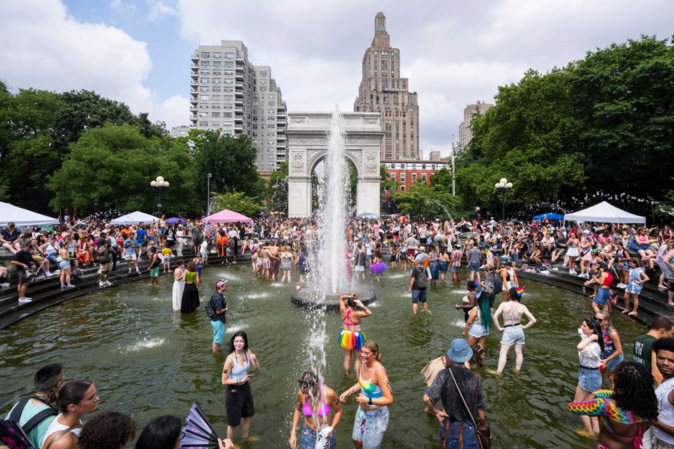 People celebrate in Washington Square Fountain at Washington Square Park after the New York City Pride March on June 30, 2024