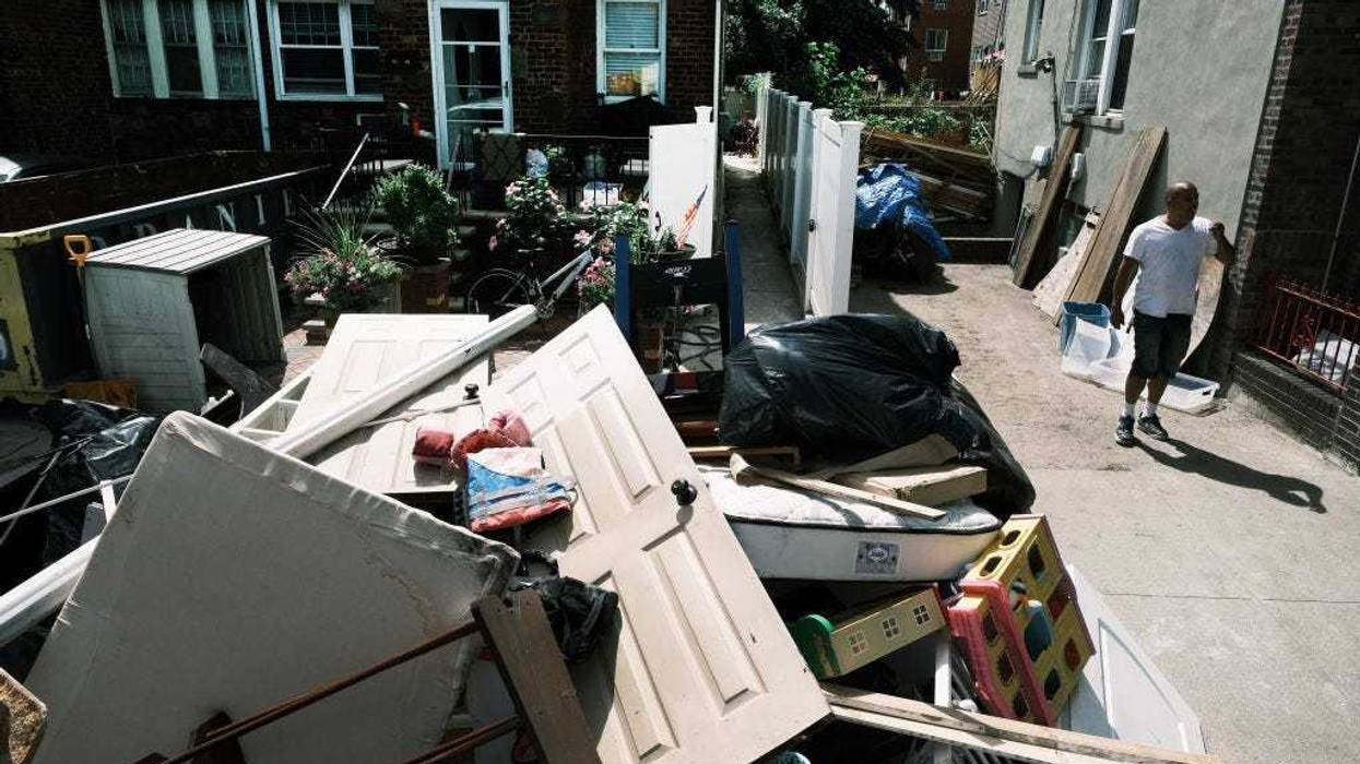 People clean up their flooded homes in a Queens neighborhood that saw massive flooding and numerous deaths following a night of heavy wind and rain from the remnants of Hurricane Ida on September 03, 2021 in New York City. Over 40 people were killed on the East Coast by tornadoes and flash floods did heavy damage to parts of New York and New Jersey as the evening storm caught many off guard with the severity of its rain, wind and flooding.