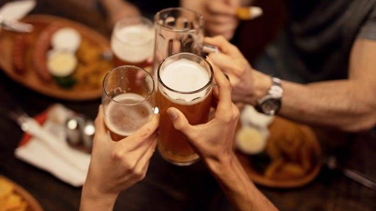 People Clink Glasses of Alcoholic Beverages - Getty Images