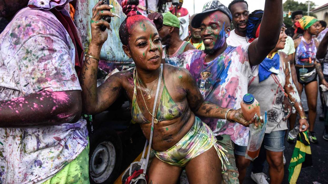 People cover themselves with paint and powder called "playing mas" during a Caribbean street carnival starting at dawn called J'Ouvert on September 4, 2023 in the Brooklyn borough in New York City. J'Ouvert originates from the French words "jour ouvert," meaning daybreak and signals the start of Carnival. Carnival is the traditional street festival honoring the vast heritage and culture of the Caribbean diaspora.