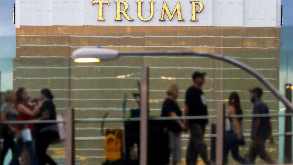 People cross an overpass along the Las Vegas Strip in front of the Trump International Hotel one day before midterms Election Day on November 7, 2022 in Las Vegas, Nevada. Several races in the swing state of Nevada, including the Senate race, are close as former President Donald Trump has endorsed Republicans including Senate candidate Adam Laxalt and gubernatorial candidate Joe Lombardo. (Photo by Mario Tama/Getty Images)