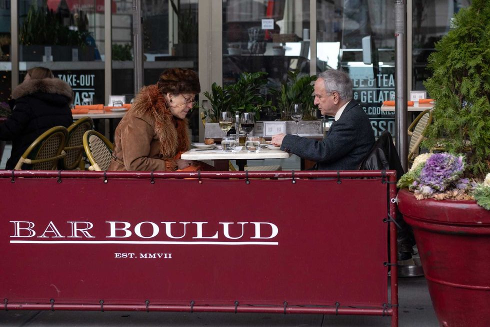 People dine outdoors at Epicerie Boulud on Christmas Day on December 25, 2020 in New York City. Many restaurants chose to stay open or work shorter hours on Christmas Eve and Christmas Day as a way to recoup profits as the pandemic continues to burden restaurants and bars struggling to thrive with evolving government restrictions.