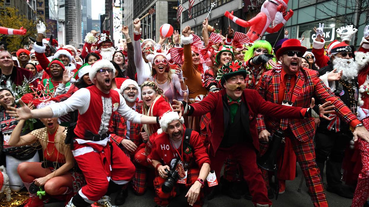 People dressed in Santa Claus costumes participate in SantaCon on December 11, 2021 in New York City.