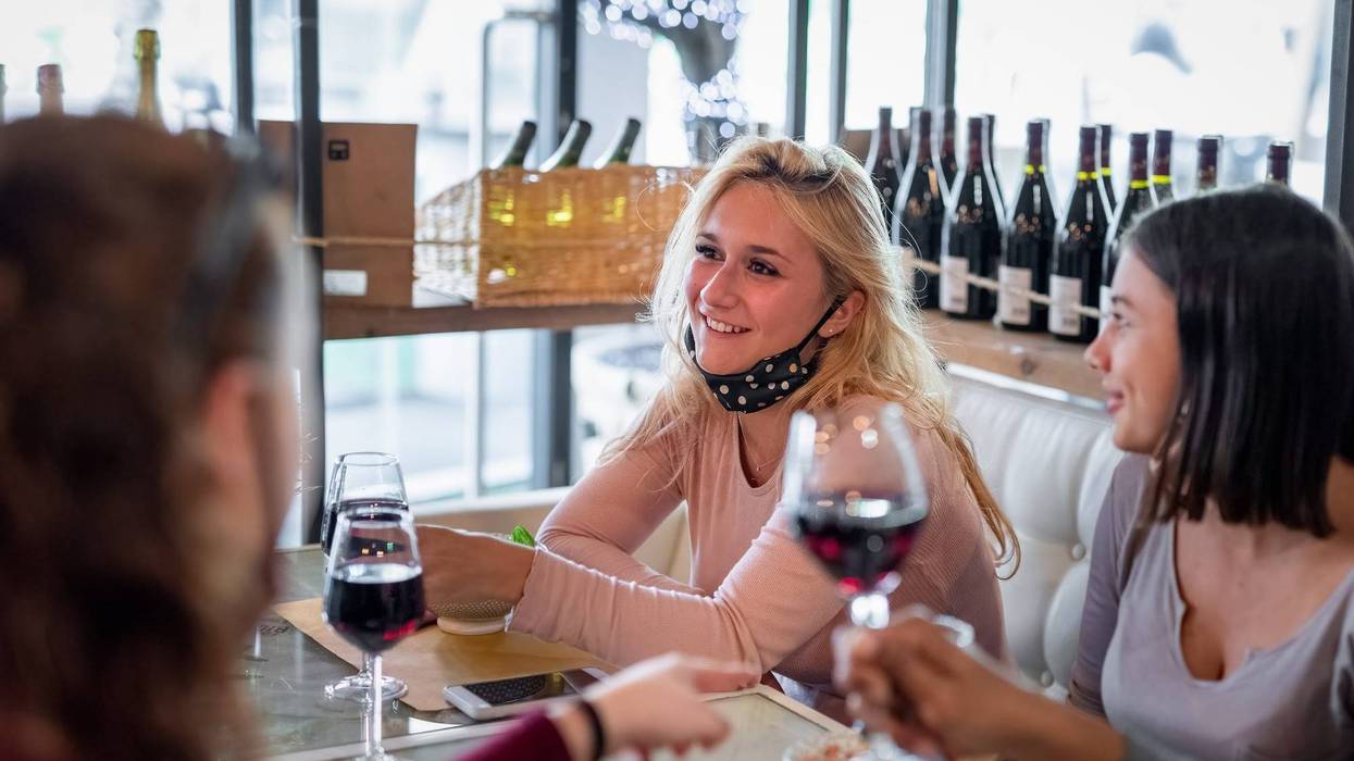 People eating indoors with masks off.