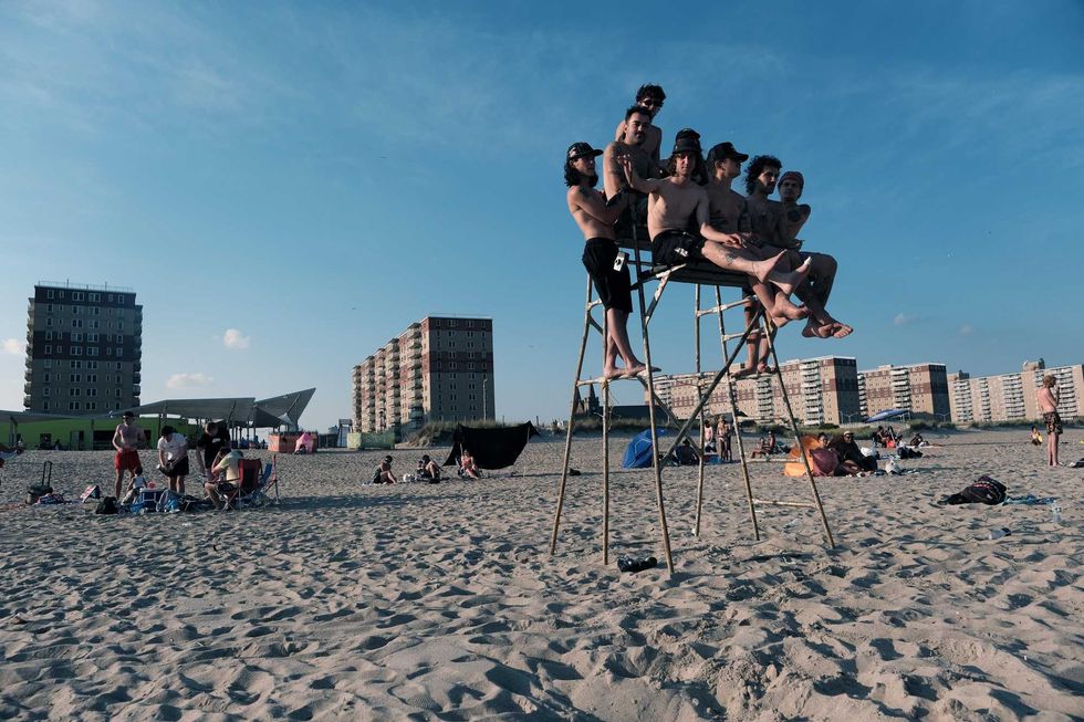 People enjoy a warm evening at Rockaway Beach on July 19, 2022 in New York City