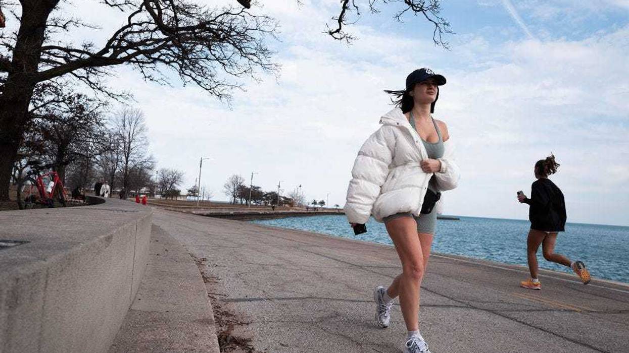 People enjoy the lakefront as temperatures climbed to near 60 degrees, more than 20 degrees above normal on February 08, 2024 in Chicago, Illinois. The warmer-than-usual day came on the same day that Scientists announced the world surpassed a key warming threshold across an entire year for the first time on record. (Photo by Scott Olson/Getty Images)