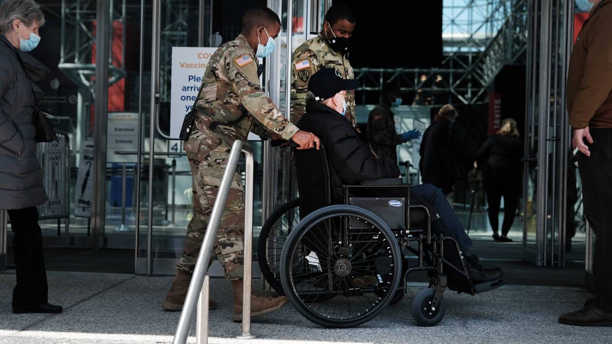 People enter and exit the Javits Center Covid-19 vaccination site on March 23, 2021 in New York City