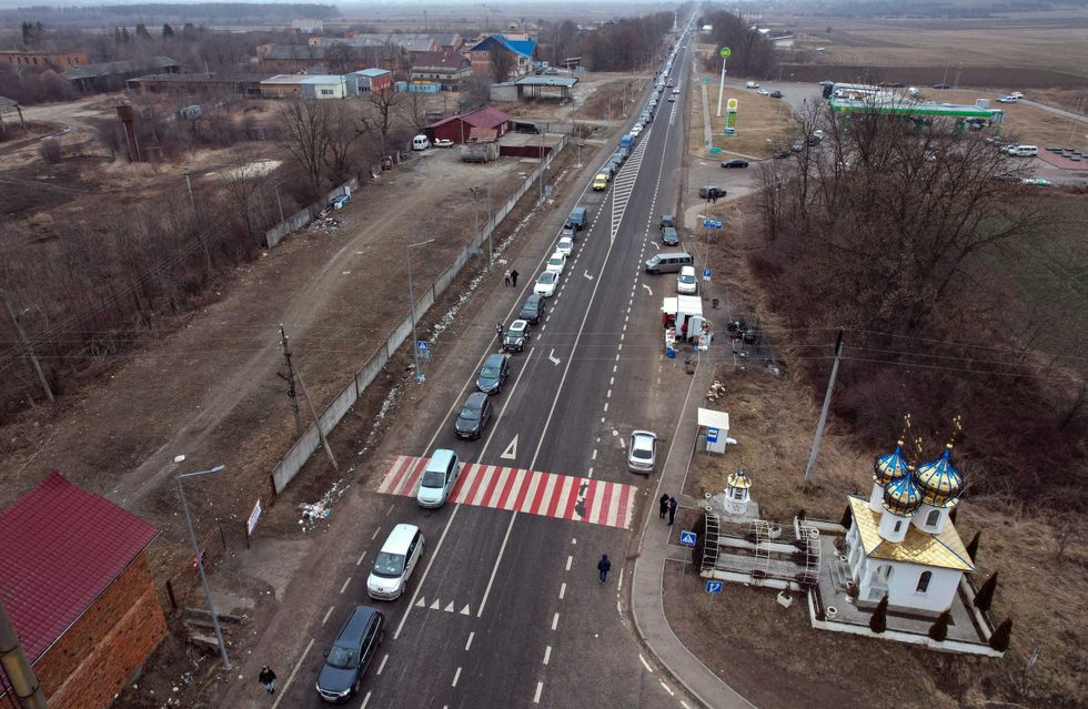 People fleeing from the conflict drive cars heading to the Ukrainian and Romania border near Cernivtsi, in Ukraine, Tuesday, March 1, 2022