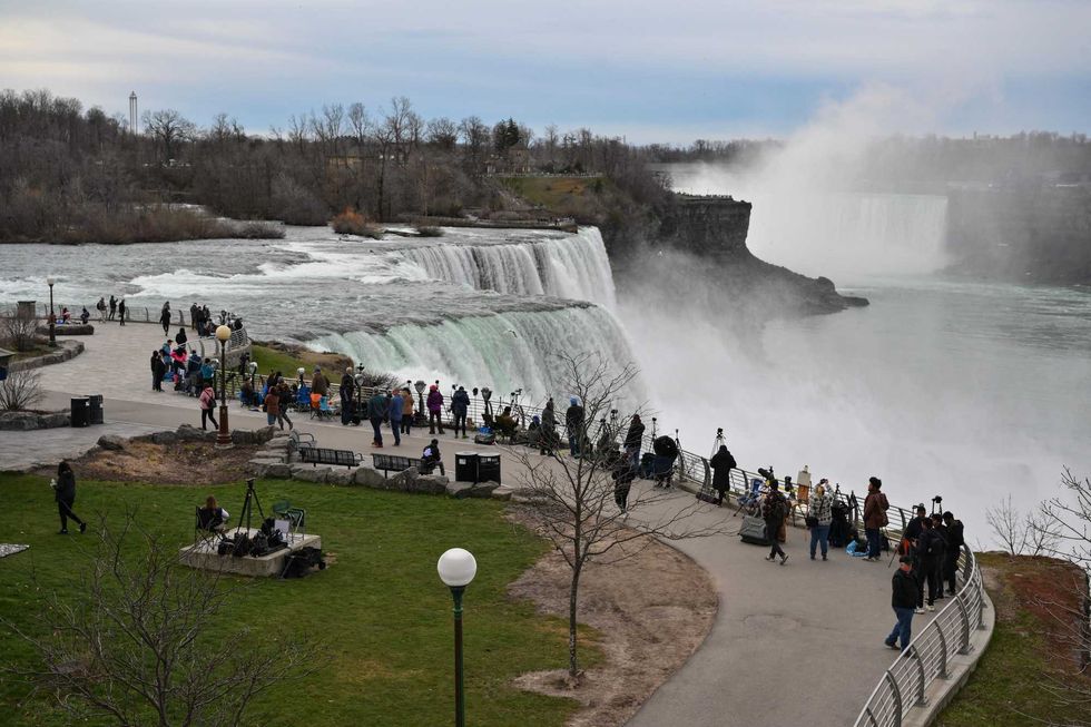 People gather at Niagara Falls State Park ahead of a total solar eclipse across North America, in Niagara Falls, New York, on April 8, 2024