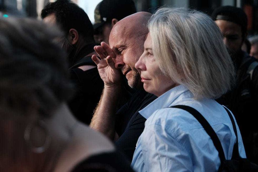 People gather in lower Manhattan near Ground Zero as the city commemorates the 20th anniversary of the September 11th terrorist attacks on the World Trade Center on September 11, 2021 in New York City.