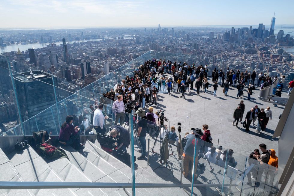 People gather on the observation deck of Edge at Hudson Yards before a partial solar eclipse on April 8, 2024