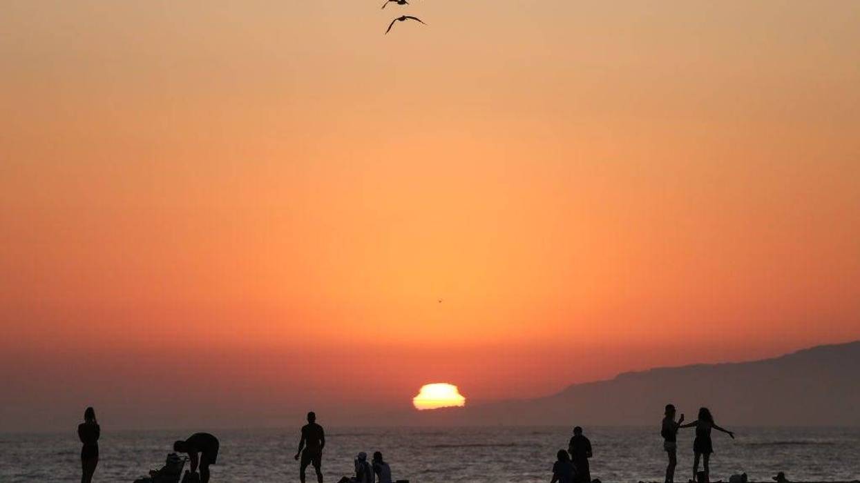 People gather on Venice Beach at sunset on the first day of the Labor Day weekend amid a heatwave on September 5, 2020 in Venice, California.