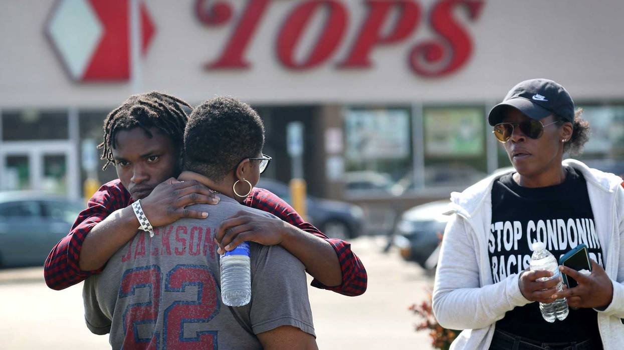 People gathered outside of Tops market embrace on May 15, 2022 in Buffalo, New York. Yesterday a gunman opened fire at the store, killing ten people and wounding another three. Suspect Payton Gendron was taken into custody and charged with first degree murder. U.S. Attorney Merrick Garland released a statement, saying the US Department of Justice is investigating the shooting "as a hate crime and an act of racially-motivated violent extremism."