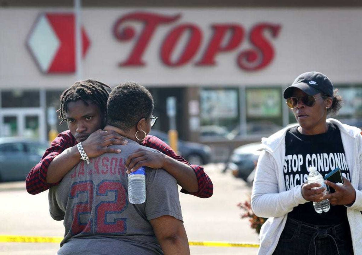 People gathered outside of Tops market embrace on May 15, 2022 in Buffalo, New York. Yesterday a gunman opened fire at the store, killing ten people and wounding another three.