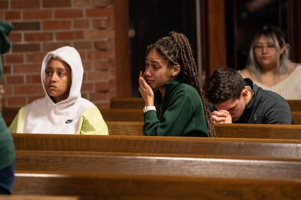 People get emotional during a vigil held at Eastminster Presbyterian Church in East Lansing on Tuesday, February 14, 2023, in memory of the students shot and killed during a mass shooting at Michigan State University