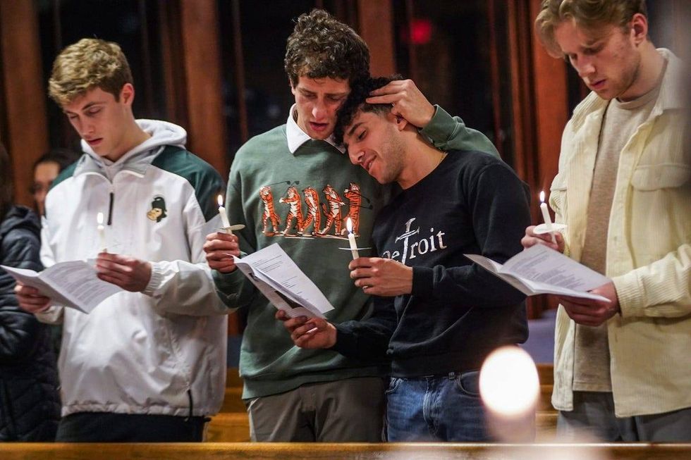 People get emotional during a vigil held at Eastminster Presbyterian Church in East Lansing on Tuesday, February 14, 2023, in memory of the students shot and killed during a mass shooting at Michigan State University.
