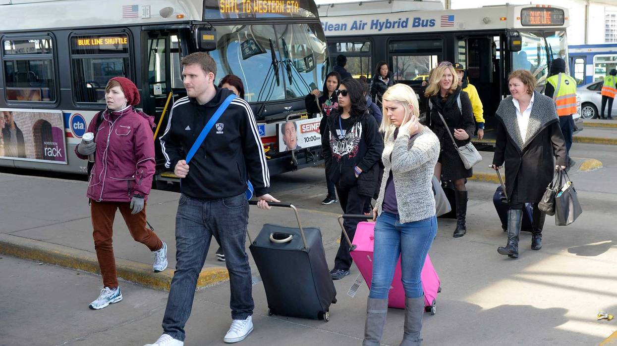 People get off buses at the Rosemont stop on the CTA Blue Line.