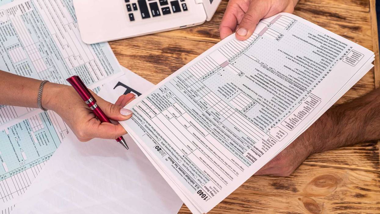 People holding tax forms.