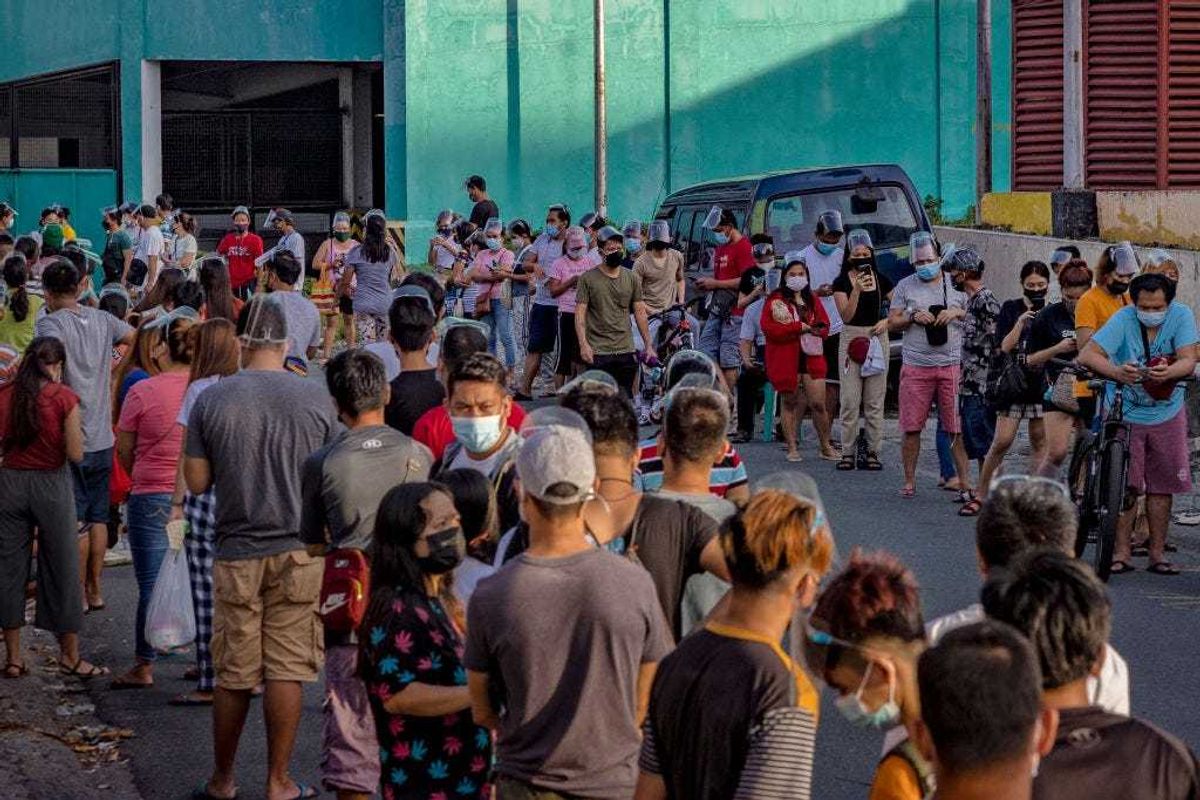 People hoping to get vaccinated against COVID-19 queue outside a vaccination site on August 08, 2021 in Las Pinas, Metro Manila, Philippines.