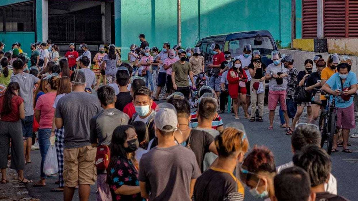 People hoping to get vaccinated against COVID-19 queue outside a vaccination site on August 08, 2021 in Las Pinas, Metro Manila, Philippines.
