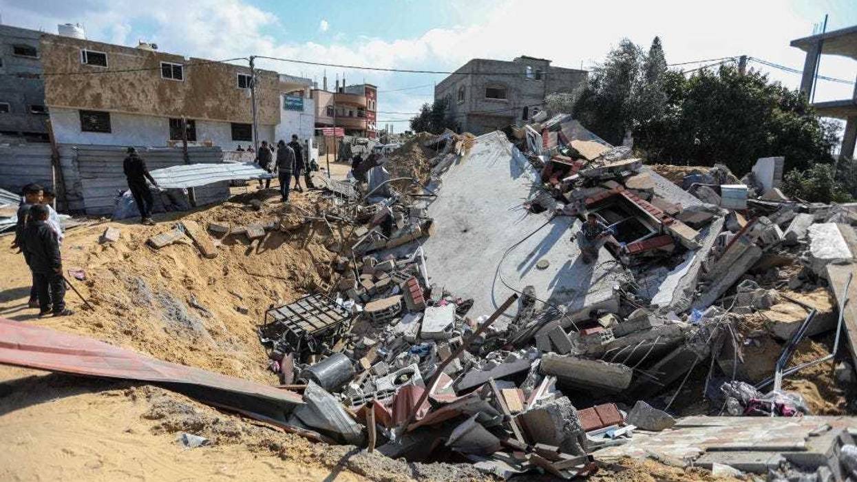 People inspect the damage to their homes following Israeli air strikes on February 20, 2024 in Rafah, Gaza. Strikes have intensified as Israel reiterated its intent to press on with a ground offensive in Gaza's southern city of Rafah where some 1.4 million internally displaced Palestinians are sheltering, whilst a growing number of countries express alarm over the operation.