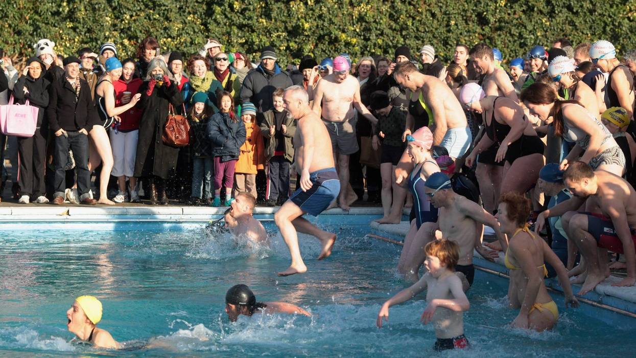 People Jumping into a freezing pool