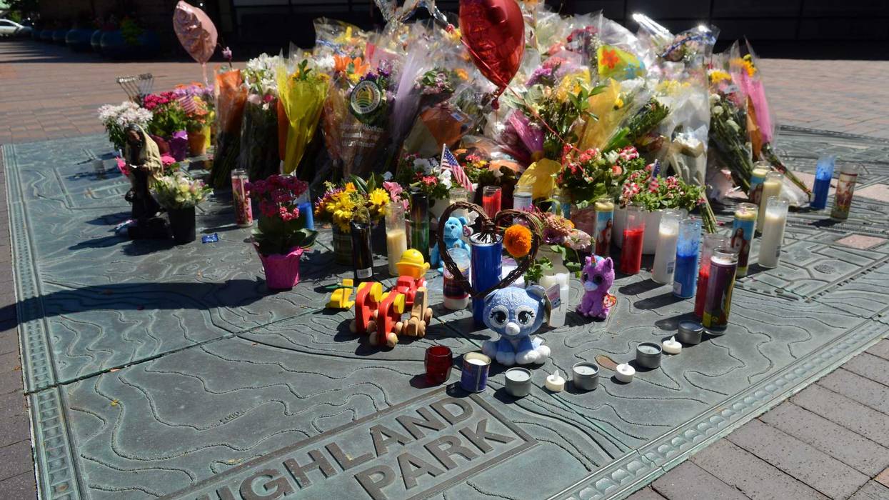 People lay flowers and cards on July 10, 2022, near a spot where a mass shooting took place during Highland Park's Fourth of July Parade.