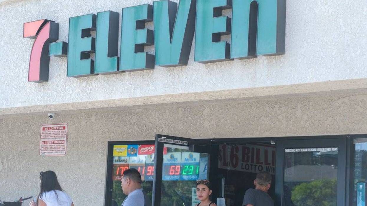 People leave a 7-Eleven convenience store.