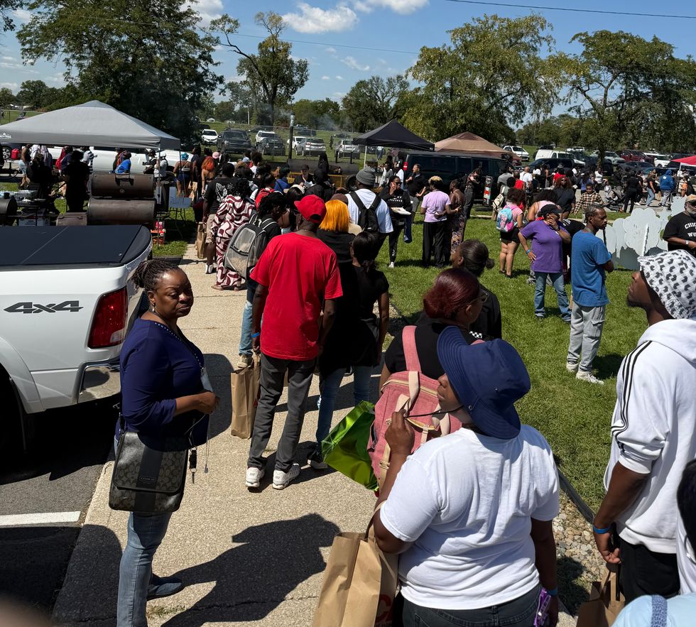 People line up for food at a storm relief event at Roosevelt Pavilion in Gary.