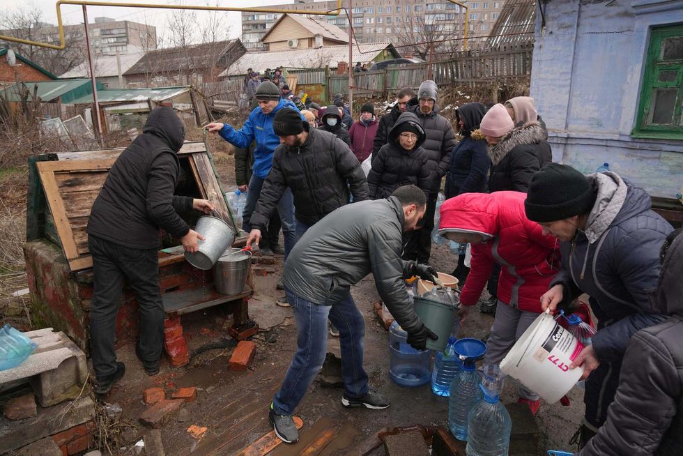 People line up to get water at the well in outskirts of Mariupol, Ukraine, Wednesday, March 9, 2022