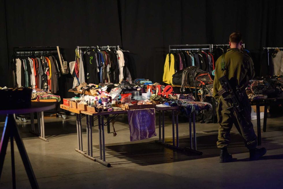 People look at "lost and found" tables with personal items collected from the Nova festival site at the