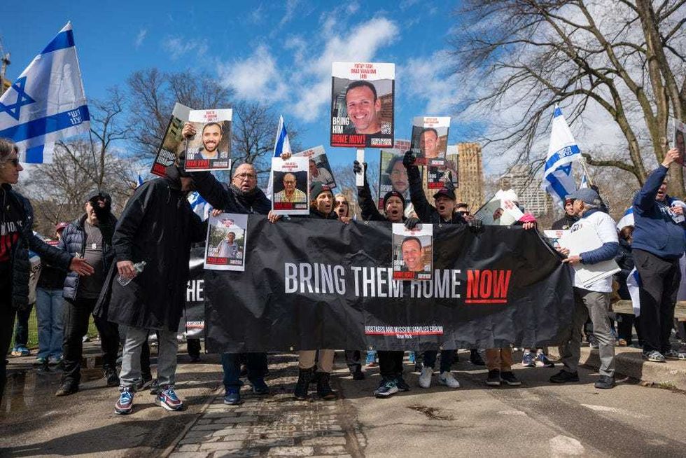 People participate in a march and rally to demand that the Israeli hostages being held in Gaza be brought home on March 10, 2024 in New York City. Holding placards and carrying Israeli flags, dozens walked through Central Park demanding that the 134 people still being held hostage in Gaza be freed. All were captured in the October 7 Hamas attack on Israel, in which over 1,000 Israelis were were killed.